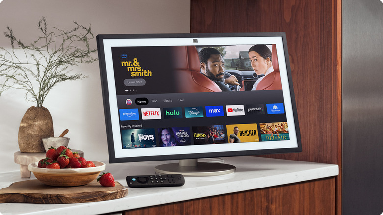 The Amazon Echo Show 21 smart display placed on a countertop, showing the Prime Video interface.