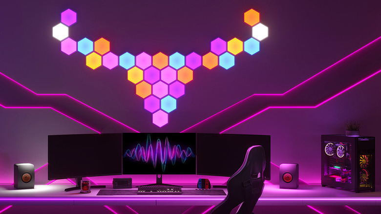 The Govee Glide Hexa smart light panels installed on a wall behind computer monitors.