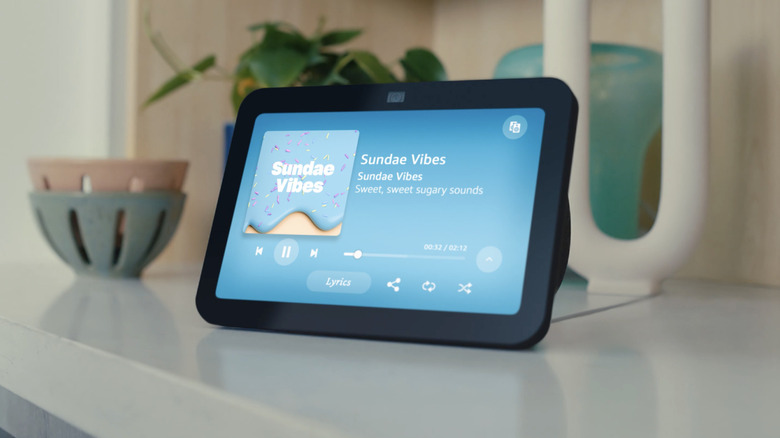 Amazon echo show on a white table playing a song