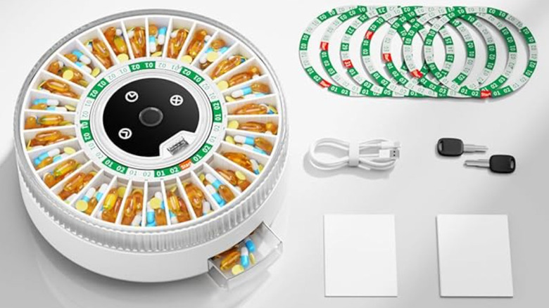 A smart pill dispenser on a white table