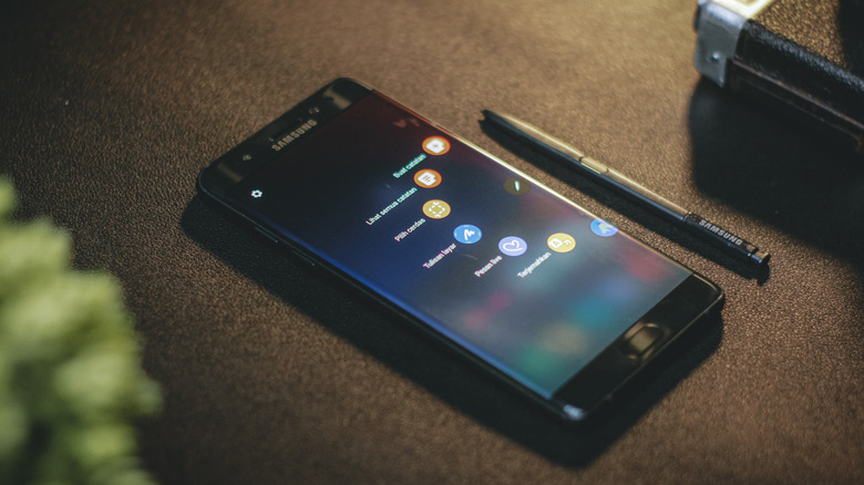 A Samsung smartphone face-up on a desk