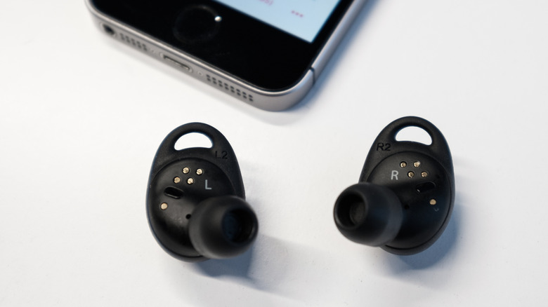 The Samsung Gear IconX on a white desk.