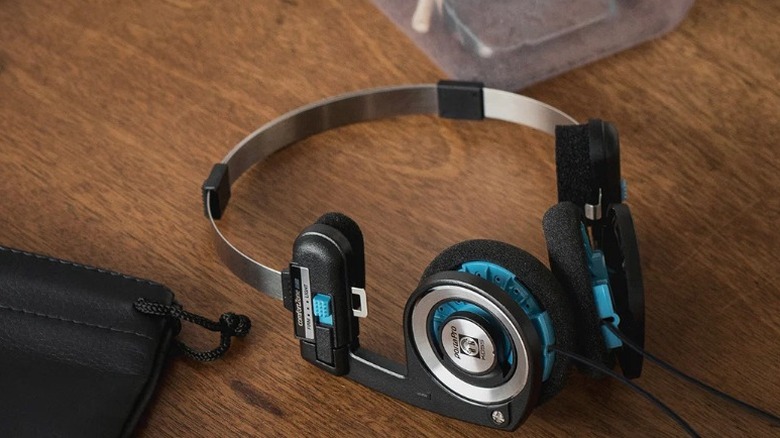 A pair of Koss Porta Pro on-ear headphones on a wooden surface.