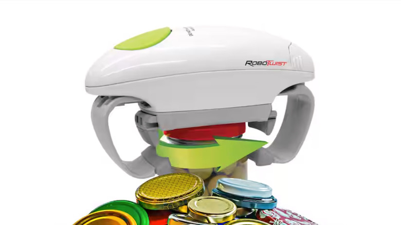 A white Robo Twist Hands-Free Easy Jar Opener atop an olive jar with a green arrow graphic laid over it.