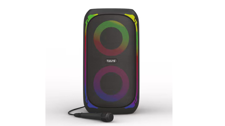 A black Tzumi Super Bass Jobsite Speaker with a microphone in front of it on a white background.