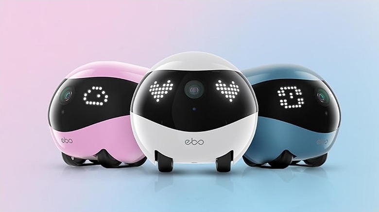 Pink, white, and blue Enabot Air 2 bots against a pastel background.