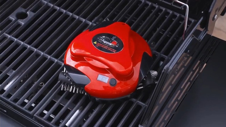 Red and black grill cleaner on a grill.