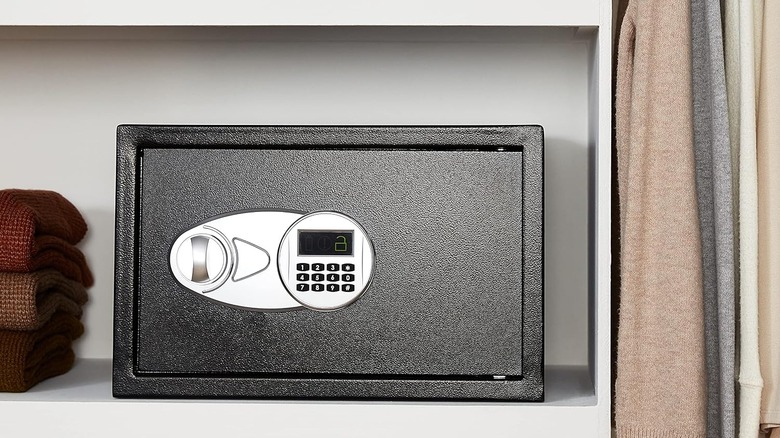 The Amazon Basics 25EI steel security safe on a shelf.