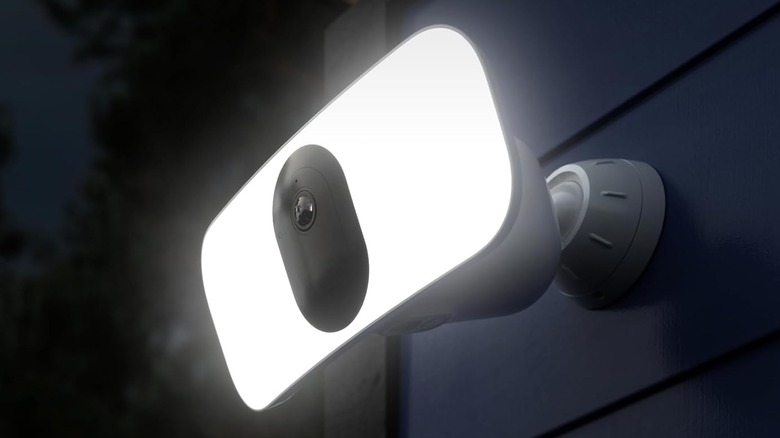 The Arlo Pro 3 Floodlight camera installed outdoors, with its floodlight activated.