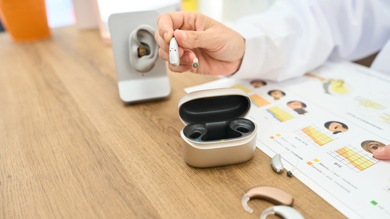 An audiologist showing different types of hearing aids