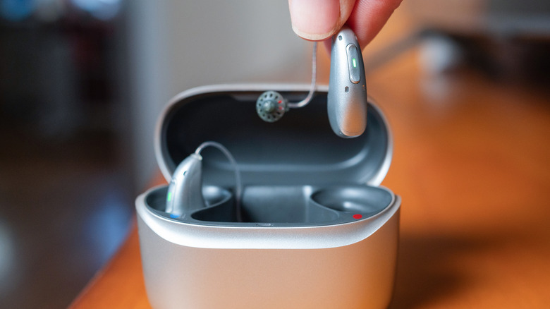 Hearing aids being taken out of their case