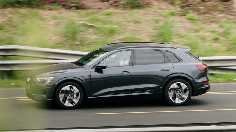 A 2024 Audi Q8 E-Tron driving on a highway.