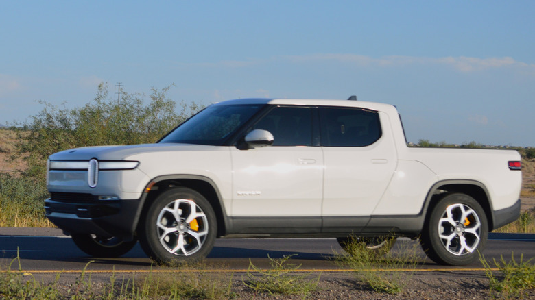 A 2025 Rivian R1T pickup truck driving through the American southwest.