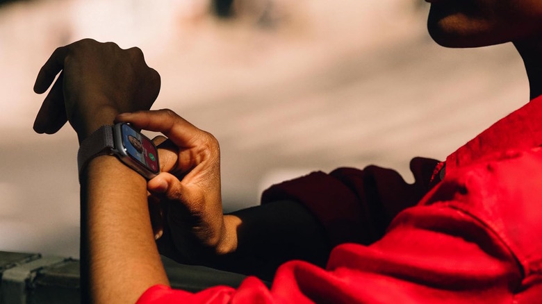 Woman looks down at her Apple Watch as she receives a call