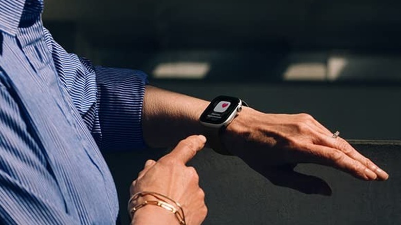Woman looks down at her Apple Watch for a health update