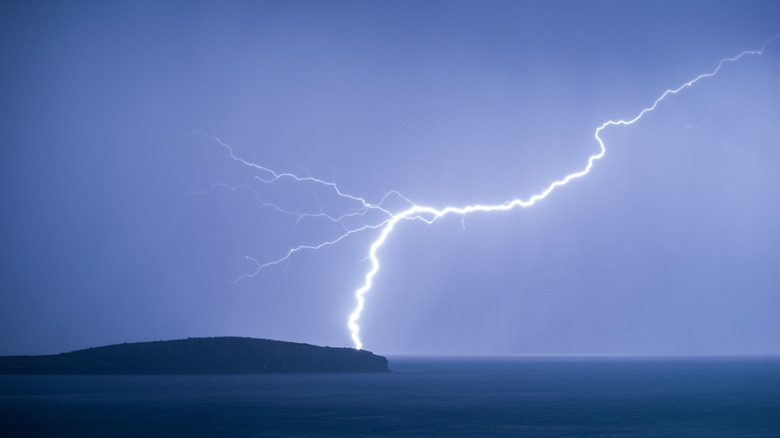 Lightning striking an island with clear sky