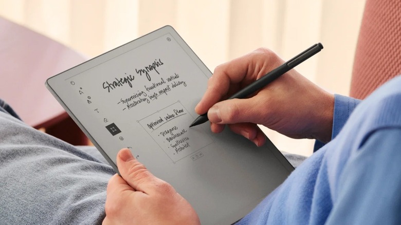 A person writing on the remarkable Paper Pure digital notebook.