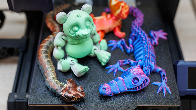 3D printed toys sitting on a print build plate. Patreon creators offer 3D models of all types.