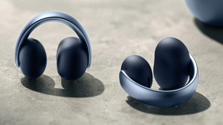 a pair of blue Soundcore Aeroclip earbuds on a concrete surface