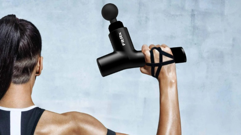 Someone holding the FitRx Massage Gun