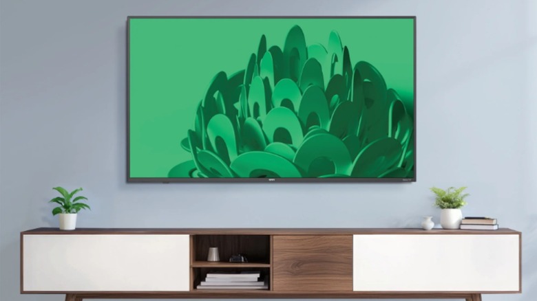 A Onn 50 Class 4K UHD TV mounted on a wall