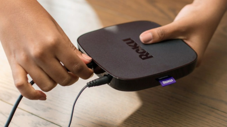 Someone plugging in the Roku Ultra LT 2019