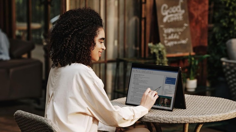 A person using the stylus to navigate the LG Gram Pro 2-in-1