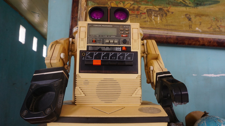 A vintage toy robot with cassette-programming controls and articulated arms.