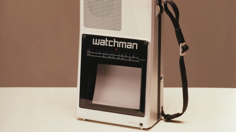 A Sony Watchman portable black-and-white television with a built-in speaker and wrist strap.