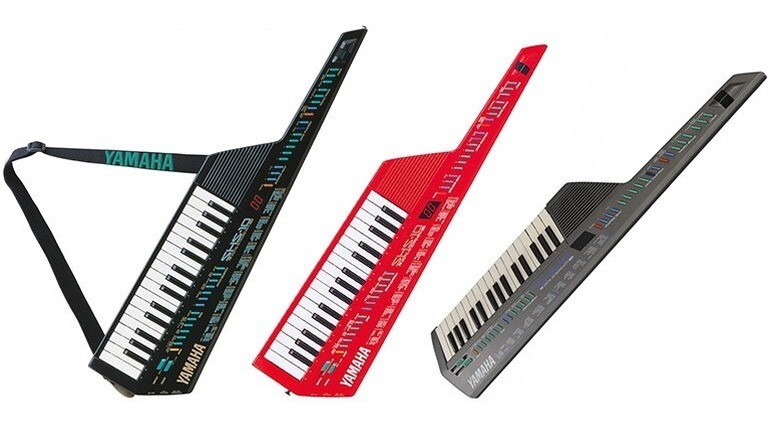 Three Yamaha keytar synthesizers in different colors displayed side by side.