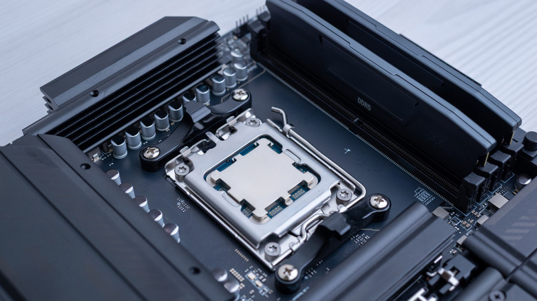 A close-up of a desktop CPU installed in a motherboard socket beside memory slots on a generic black motherboard.