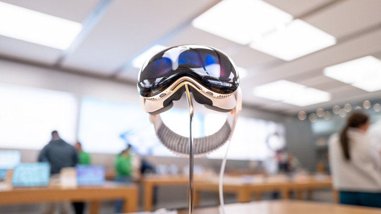 The Apple Vision Pro mixed-reality headset displayed on a stand inside an Apple Store.