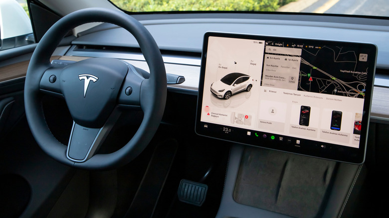 The interior of a Tesla, showing a large screen.