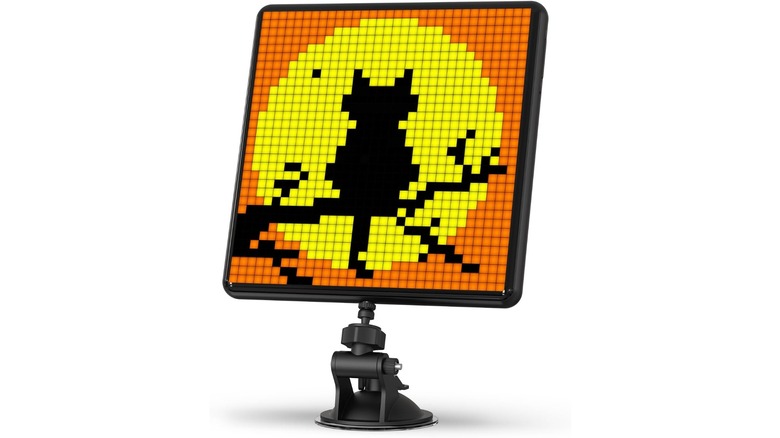 A pixel display screen with an image of a cat sitting on a tree branch silhouetted by the moon.