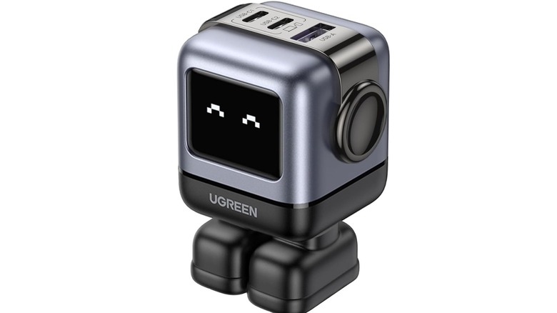 A UGREEN Uno 65W that looks like a little robot with a happy face on a white background.