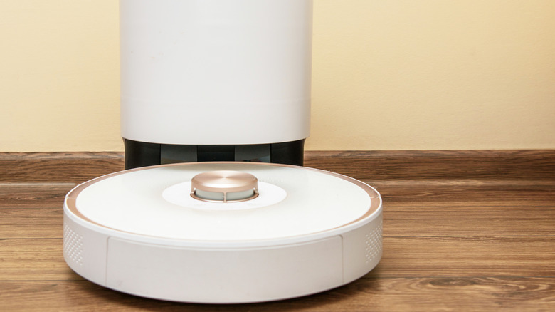 White robot vacuum in its dock