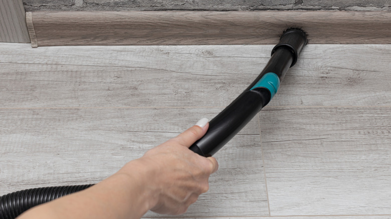 Vacuuming the edge with a brush head tool