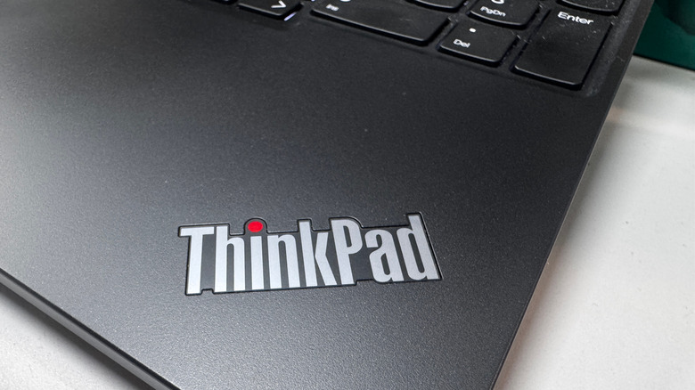 A closeup of the Lenovo ThinkPad logo on the top surface of an open ThinkPad.