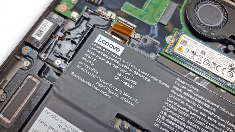 Close-up of internal components of a Lenovo ThinkPad, including the SSD in its slot.