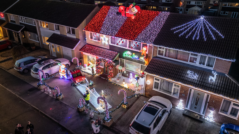 A house on a British street with far too many lights on, decorated for Christmas