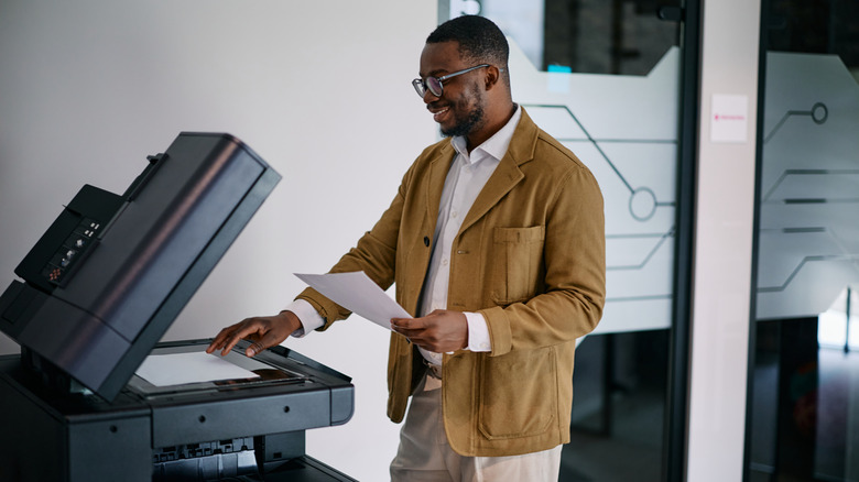 Man using a printer scanner in an office