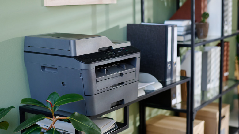Wireless printer scanner on a shelf in an office