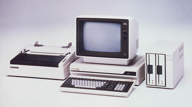 An NEC PC-98 next to a printer and external drive enclosure.