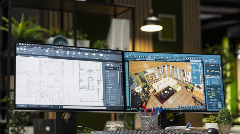 Two computers sit on a desk in dual-monitor mode.