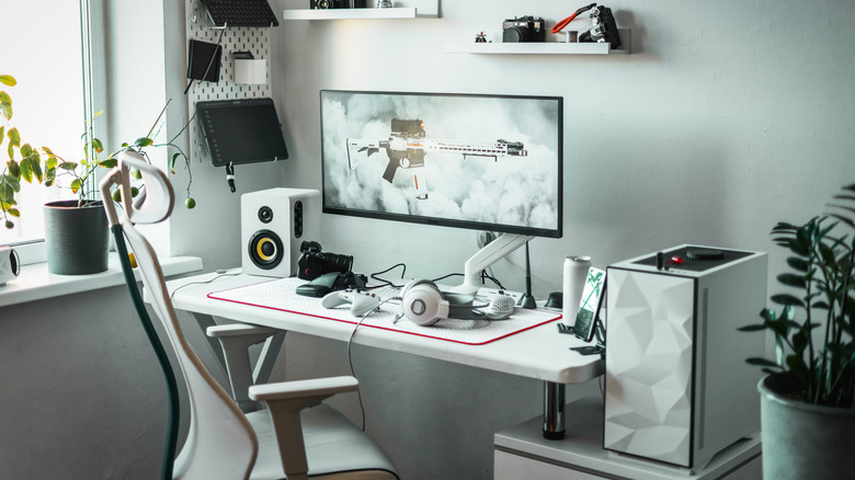 A clean computer setup featuting an ultrawide monitor.