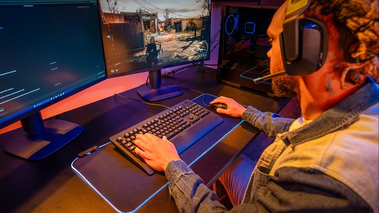 Person playing video games on gaming PC