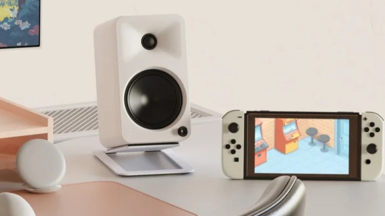 The Kanto Ora4 speaker on a desk with a Nintendo Switch next to it.