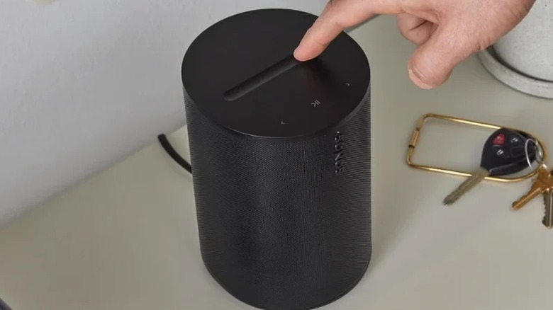 A person pressing the capacitive volume bar on the Sonos Era 100 SL wireless speaker.
