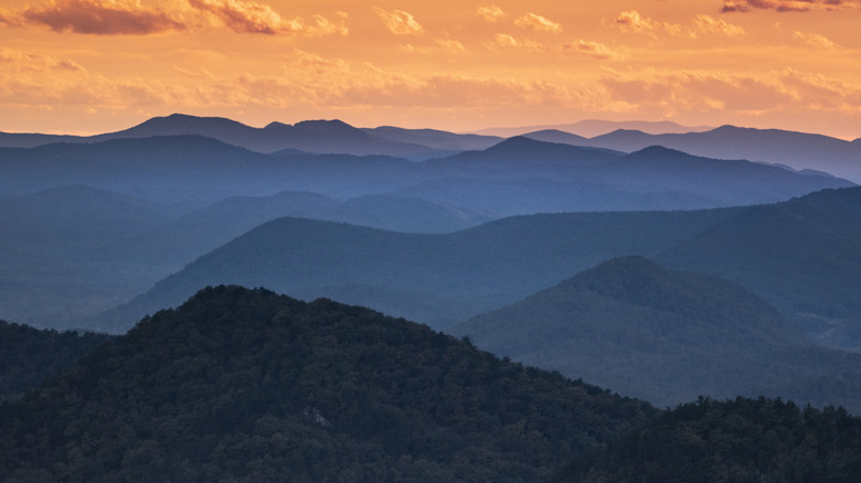 Mountains seen with an orange sky.