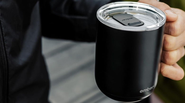 A person holding the Ember Mug 2